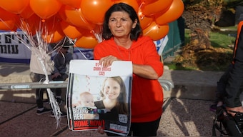 A supporter holds a portrait of of Shiri and Kfir Bibas, the youngest hostage to be kidnapped by Hamas on the October 7 attack together with his mother and brother. File image/AFP