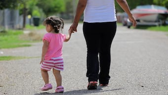 In this September 16, 2015, photo, a woman in Sullivan City, Texas, who said she entered the country illegally, walks with her daughter who was born in the United States, but was denied a birth certificate. AP File
