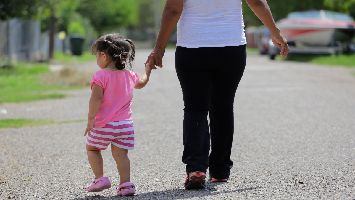 In this September 16, 2015, photo, a woman in Sullivan City, Texas, who said she entered the country illegally, walks with her daughter who was born in the United States, but was denied a birth certificate. AP File In this September 16, 2015, photo, a woman in Sullivan City, Texas, who said she entered the country illegally, walks with her daughter who was born in the United States, but was denied a birth certificate. AP File