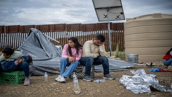 An Indian family wait to be apprehended by US Customs and Border protection officers after crossing over into the US in Ruby, Arizona. Many Indians put everything on the line to reach US and achieve their "American Dream". File image/AFP