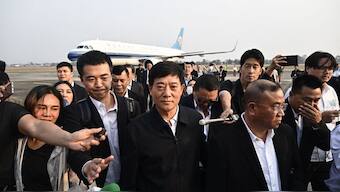 Chinese Public Security Assistant Minister Liu Zhongyi (C) is surrounded by media after inspecting the repatriation of alleged scam centre workers and victims from China, at Mae Sot International Airport in Tak province on February 20, 2025. Hundreds of Chinese workers were heading home on February 20, 2025 after being freed from online scam centres in Myanmar, as authorities crack down on the illegal operations.