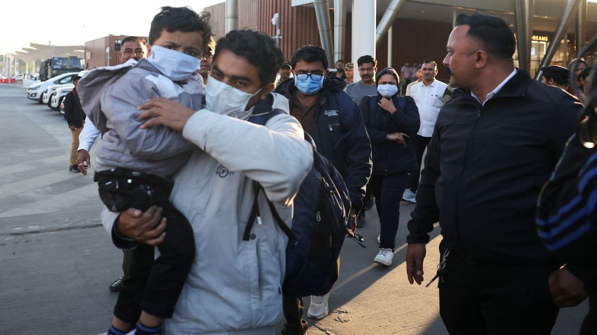 Indian immigrants deported from the US, walk out of the airport in Ahmedabad, India on February 6. Hundred and four deportees were sent back on a military aircraft. Reuters Indian immigrants deported from the US, walk out of the airport in Ahmedabad, India on February 6. Hundred and four deportees were sent back on a military aircraft. Reuters