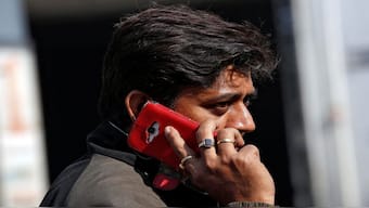 A man talks on his mobile phone while walking on a road in Kolkata. Representational image/Reuters