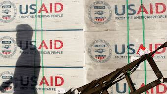 The shadow of a Philippine Army personnel is cast on boxes of relief items from USAID for the victims of super typhoon Haiyan, at Villamor Air Base in Manila in 2013. File image/Reuters