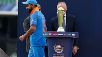 Virat Kohli walks past the Champions Trophy after losing to Pakistan in the 2017 final. Image: Reuters