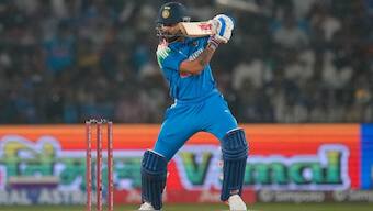 Virat Kohli batting with a tobacco product being advertised in the background. Image: AP