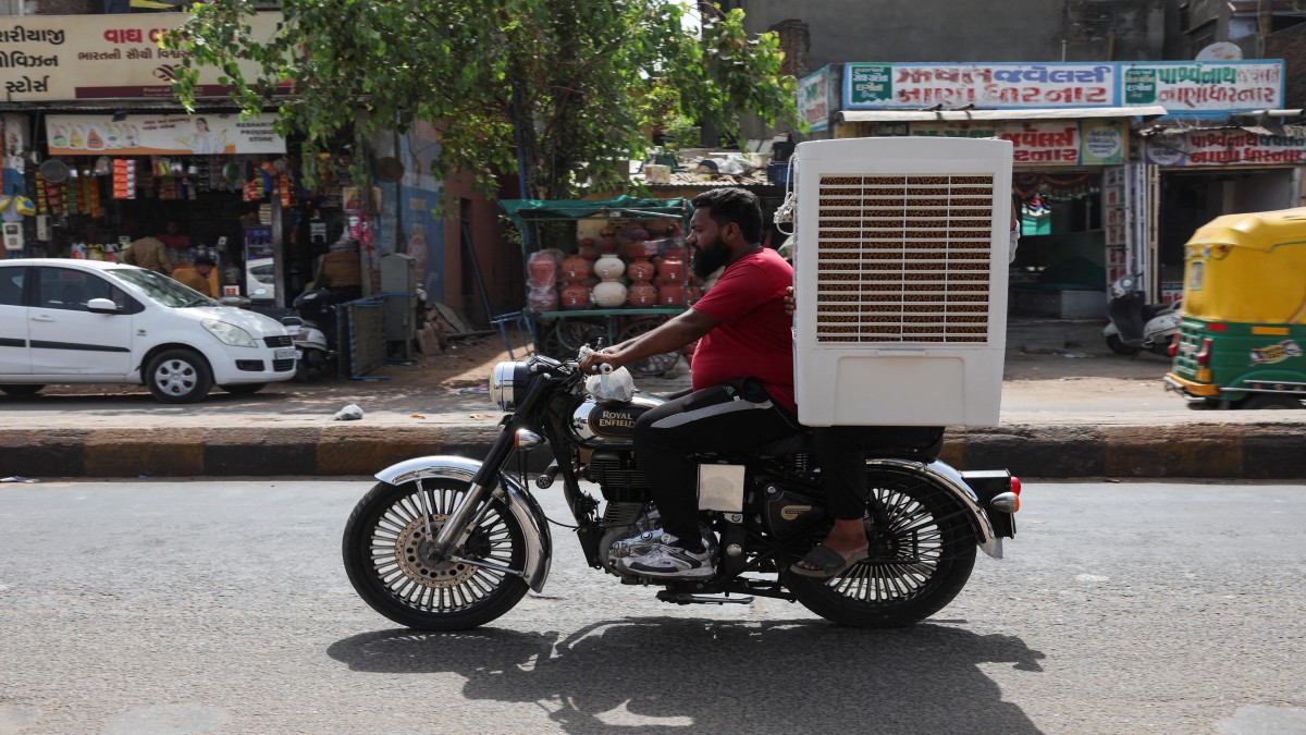A man transports an air cooler on a motorcycle during a heat wave in Ahmedabad, India. Reuters/Representational Image A man transports an air cooler on a motorcycle during a heat wave in Ahmedabad, India. Reuters/Representational Image