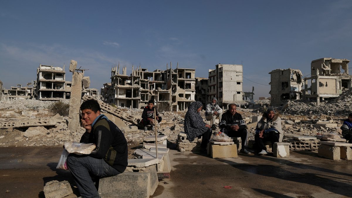 People sit after receiving bread from Ecir Kapici, Turkish humanitarian NGO at al-Yarmouk Palestinian refugee camp, after Syria's Bashar al-Assad was ousted, in Damascus, Syria. File image/ Reuters People sit after receiving bread from Ecir Kapici, Turkish humanitarian NGO at al-Yarmouk Palestinian refugee camp, after Syria's Bashar al-Assad was ousted, in Damascus, Syria. File image/ Reuters