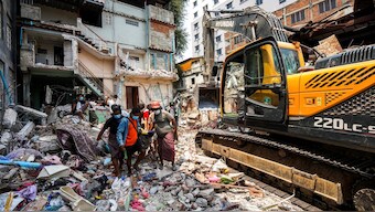 Rescuers carry the body of a victim, in the aftermath of a strong earthquake, in Mandalay, Myanmar. Reuters