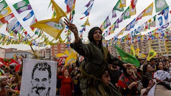 A man holds a flag with an image of jailed Kurdish militant leader Abdullah Ocalan as people gather to celebrate spring festival of Newroz in the southeastern town of Kiziltepe in Mardin province, Turkey. Reuters