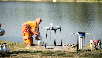A village woman collecting water from mobile water unit