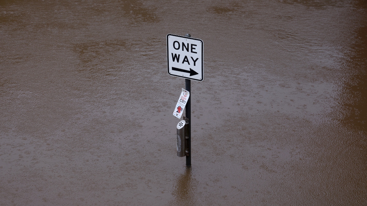 A traffic sign stands submerged in floodwater at the edge of the Wilsons River near Lismore's CBD on March 9, 2025. AFP A traffic sign stands submerged in floodwater at the edge of the Wilsons River near Lismore's CBD on March 9, 2025. AFP