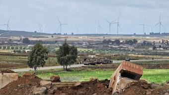 Israeli army tanks and a bulldozer drive through the Abu Diab military post on the southern outskirts of the border town of Quneitra. AFP