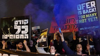 Demonstrators march with signs in central Tel Aviv during an anti-government protest calling for action to secure the release of Israeli hostages held captive in the Gaza Strip since the October 7 attacks by Palestinian militants. AFP