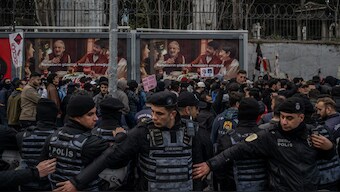 Turkish anti riot police officers stand guard as students take part in a rally in support of Istanbul arrested mayor, in Istanbul. AFP