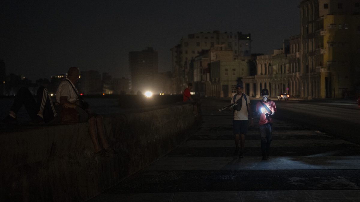 Residents walk on a street during a general blackout in Havana, Cuba. AP Residents walk on a street during a general blackout in Havana, Cuba. AP