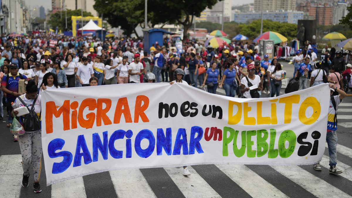 People hold a banner that reads in Spanish, "Migrating is not a crime; sanctioning a people is," at a government-organized march to protest the deportation from the U.S. of alleged members of the Venezuelan Tren de Aragua gang, who were transferred to an El Salvador prison, in Caracas, Venezuela. AP People hold a banner that reads in Spanish, "Migrating is not a crime; sanctioning a people is," at a government-organized march to protest the deportation from the U.S. of alleged members of the Venezuelan Tren de Aragua gang, who were transferred to an El Salvador prison, in Caracas, Venezuela. AP