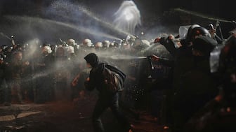 Riot police use pepper spray to clear protesters during a protest against the arrest of Istanbul's Mayor Ekrem Imamoglu, in Istanbul, Turkey. AP