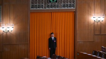 A security official stands at an entrance ahead of the Chinese People's Political Consultative Conference (CPPCC) at the Great Hall of the People in Beijing. AFP