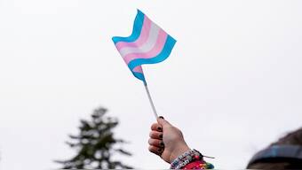A demonstrator holds a trans flag during a rally in support of trans youth in Seattle, Washington, US, on February 8, 2025. Reuters File