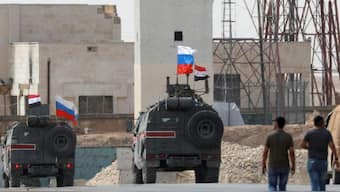 Russian flags are hoisted on military vehicles near Manbij in northern Syria. (Photo: Reuters)