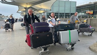 Travellers arrives at Terminal 5 as London's Heathrow Airport says it plans to resume some flights later Friday after a fire at a nearby electrical substation has caused a closure of Europe's busiest airport in London, on Friday. AP 
