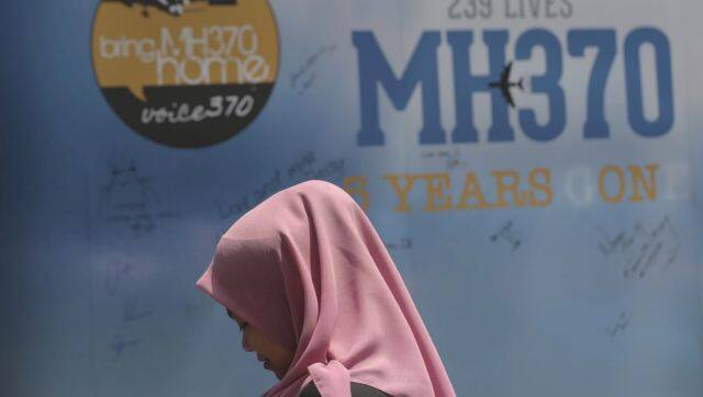 A girl stands in front of a condolence message board during Day of Remembrance for MH370 event in Kuala Lumpur. File image/AP