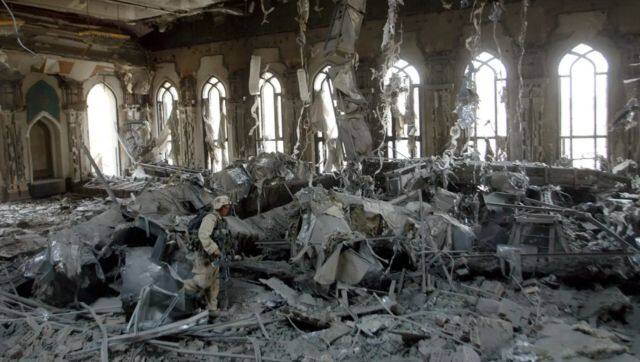 US Army soldiers search one of Saddam Hussein's palaces damaged after a bombing. File image/AP