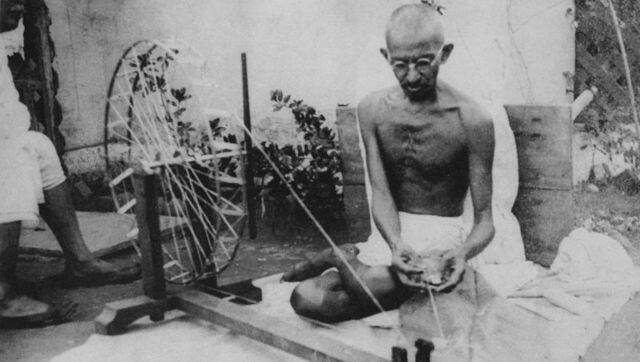 Mahatma Gandhi sits at the Birla House, spinning the charkha. Wikimedia Commons