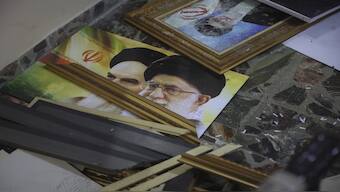 Broken pictures of Iranian spiritual leaders Ayatollah Ali Khamenei and Ayatollah Ruhollah Khomeini lie on the floor at the Iranian embassy after opposition forces took control of the city in Damascus, Syria, December 8, 2024. AP