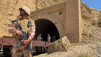 Pakistan army soldiers stand at a tunnel where the Jaffar Express train was attacked by the Baloch separatists, in Bolan, Balochistan, Pakistan. (IMAGE: REUTERS)
