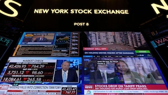 Financial news is displayed as people work on the floor at the New York Stock Exchange in New York, US, March 4, 2025. File Image/AP