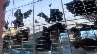 The protest escalated rapidly, with individuals throwing stones at the AMN building that shattered windows and attempts made to set it on fire. Image Courtesy: Firstpost