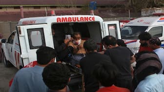 An injured man rescued by security forces from a passenger train attacked by separatist militants sits in an ambulance at a railway station in Mach, Balochistan, Pakistan, on Wednesday. Reuters 