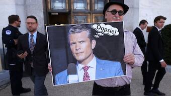 Demonstrator Gary Rush holds a placard showing a picture of US Secretary of Defence Pete Hegseth outside a Senate office building as US intelligence chiefs appeared before a Senate Intelligence Committee hearing on worldwide threats, on Capitol Hill in Washington, DC, US, March 25, 2025. File Image/Reuters