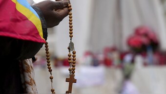 A woman holds rosary beads as she prays for Pope Francis in front of the Agostino Gemelli Polyclinic, where the Pontiff has been hospitalised since Feb.14, in Rome. AP