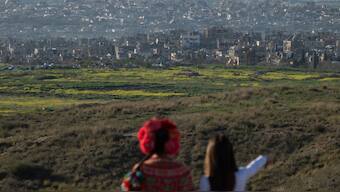 People look at buildings that were destroyed during the Israeli air and ground offensive stand in the Gaza Strip as seen from southern Israel, Sunday, March 2, 2025. (AP Photo)