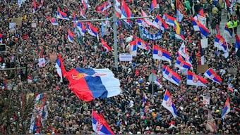 Protesters holding up the national flag take part in one of the largest anti-corruption demonstrations since the anti-graft movement in Belgrade on March 15, 2025.  Image- AFP