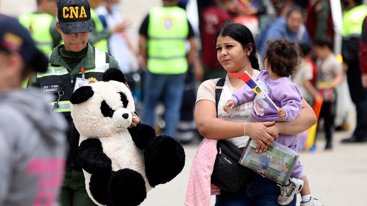 A member of the National Anti-Drug Command (CNA) accompanies a migrant woman upon arrival at Simon Bolivar International Airport in Maiquetia, Venezuela on March 20, 2025. Image- AFP A member of the National Anti-Drug Command (CNA) accompanies a migrant woman upon arrival at Simon Bolivar International Airport in Maiquetia, Venezuela on March 20, 2025. Image- AFP