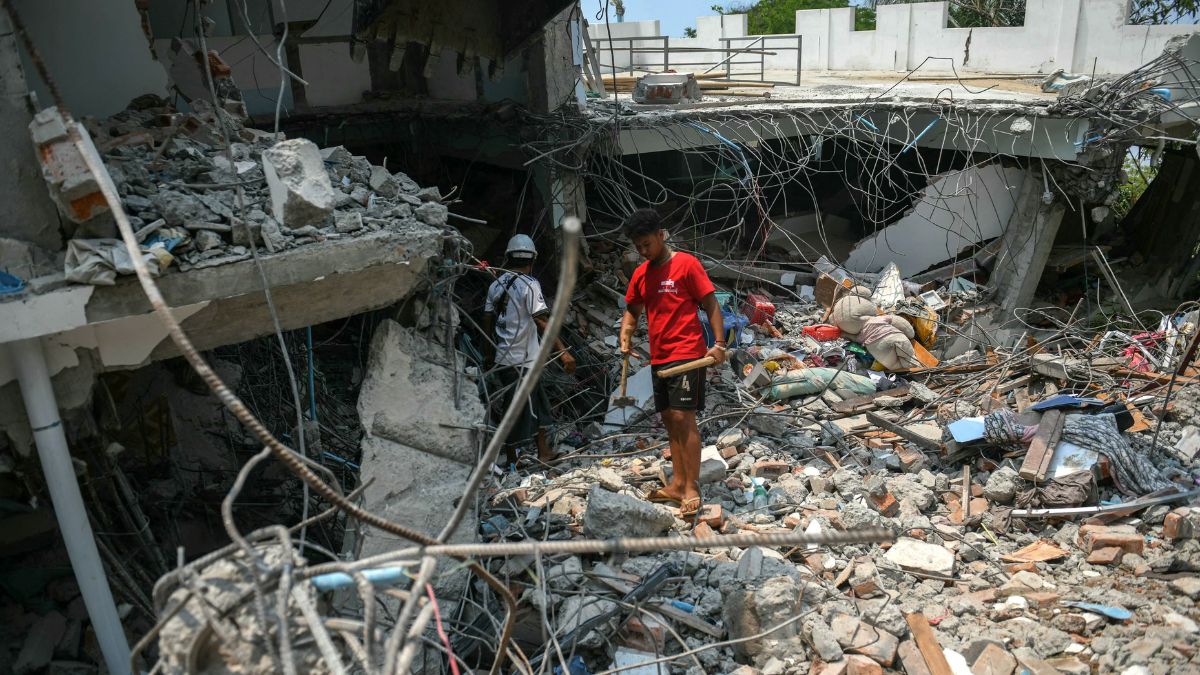 People stand next to a destroyed building as rescuers look through the rubble to find survivors in Mandalay on March 29, 2025, a day after an earthquake struck central Myanmar.Image- AFP
People stand next to a destroyed building as rescuers look through the rubble to find survivors in Mandalay on March 29, 2025, a day after an earthquake struck central Myanmar.Image- AFP