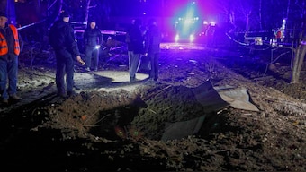 Police officers look at a crater made by a drone near apartment houses following Russia's night attack in Kharkiv, Ukraine, late Saturday, March 29, 2025. Image- AP