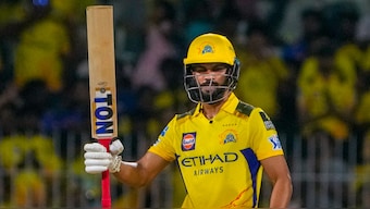 Chennai Super Kings captain Ruturaj Gaikwad raises his bat after completing his half-century against Mumbai Indians at the MA Chidambaram Stadium in Chennai. PTI