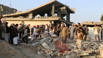 People gather on the rubble of a house hit by a US strike in Saada, Yemen, on Sunday. Reuters File 