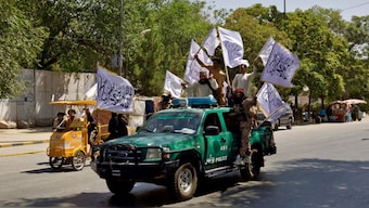 (File) Members of the Taliban carrying flags participate in a rally. Reuters