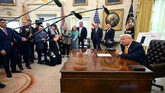 President Donald Trump speaks with reporters in the Oval Office of the White House in Washington, on Friday. 