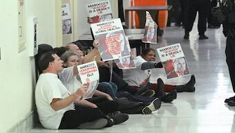 Protesters are detained by US Capitol police officers after demonstrating outside of closed-door meeting where Congressional members of the House Foreign Affairs Commitee are meeting with Pete Maroco, deputy administrator-designate for USAID (US Agency for International Development), in the Rayburn House Office Building on Capitol Hill on March 5, 2025, in Washington, DC. AFP