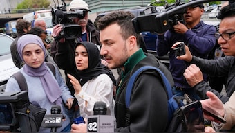 Members of the Columbia University Apartheid Divest group, including Sueda Polat, second from left, and Mahmoud Khalil, center, are surrounded by members of the media outside the Columbia University campus, April 30, 2024, in New York. File Photo/AP