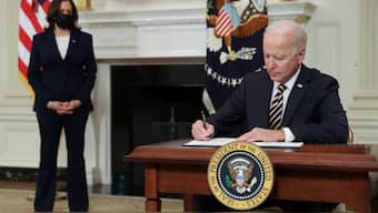 US President Joe Biden signs an executive order, aimed at addressing a global semiconductor chip shortage, as Vice President Kamala Harris stands by in the State Dining Room at the White House in Washington, US, February 24, 2021. File Photo/Reuters