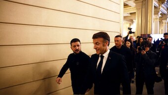 France's President Emmanuel Macron (R) and Ukraine's President Volodymyr Zelensky leave after a press conference at the Elysee Palace in Paris on March 26, 2025. AFP