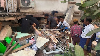 Volunteers look for survivors near a damaged building Friday, March 28, 2025, in Naypyitaw, Myanmar. AP